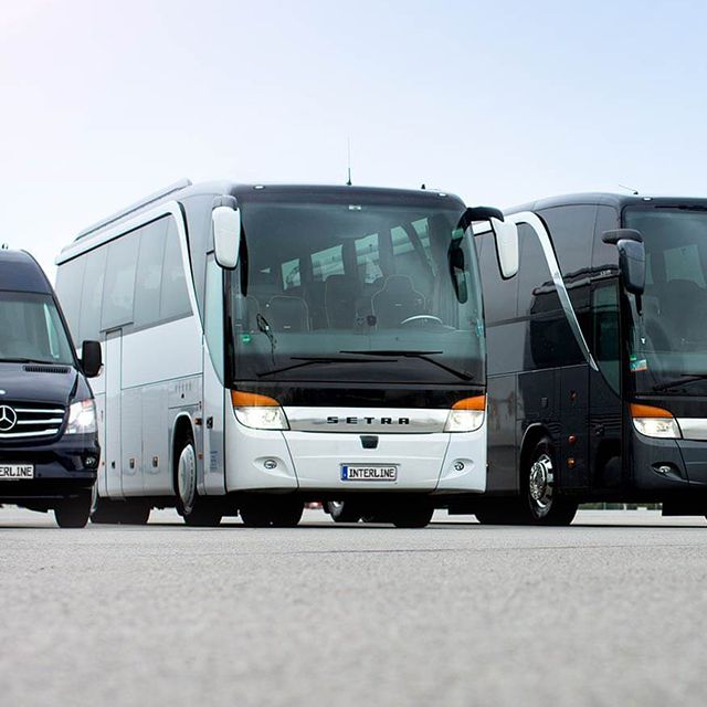 Serveral coaches on an airport.