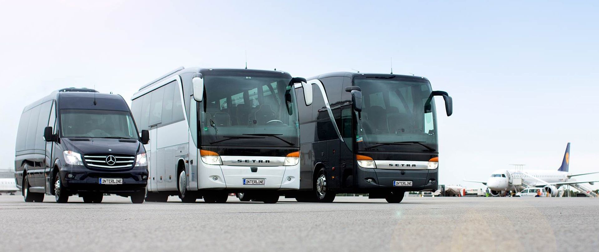 Serveral coaches on an airport.